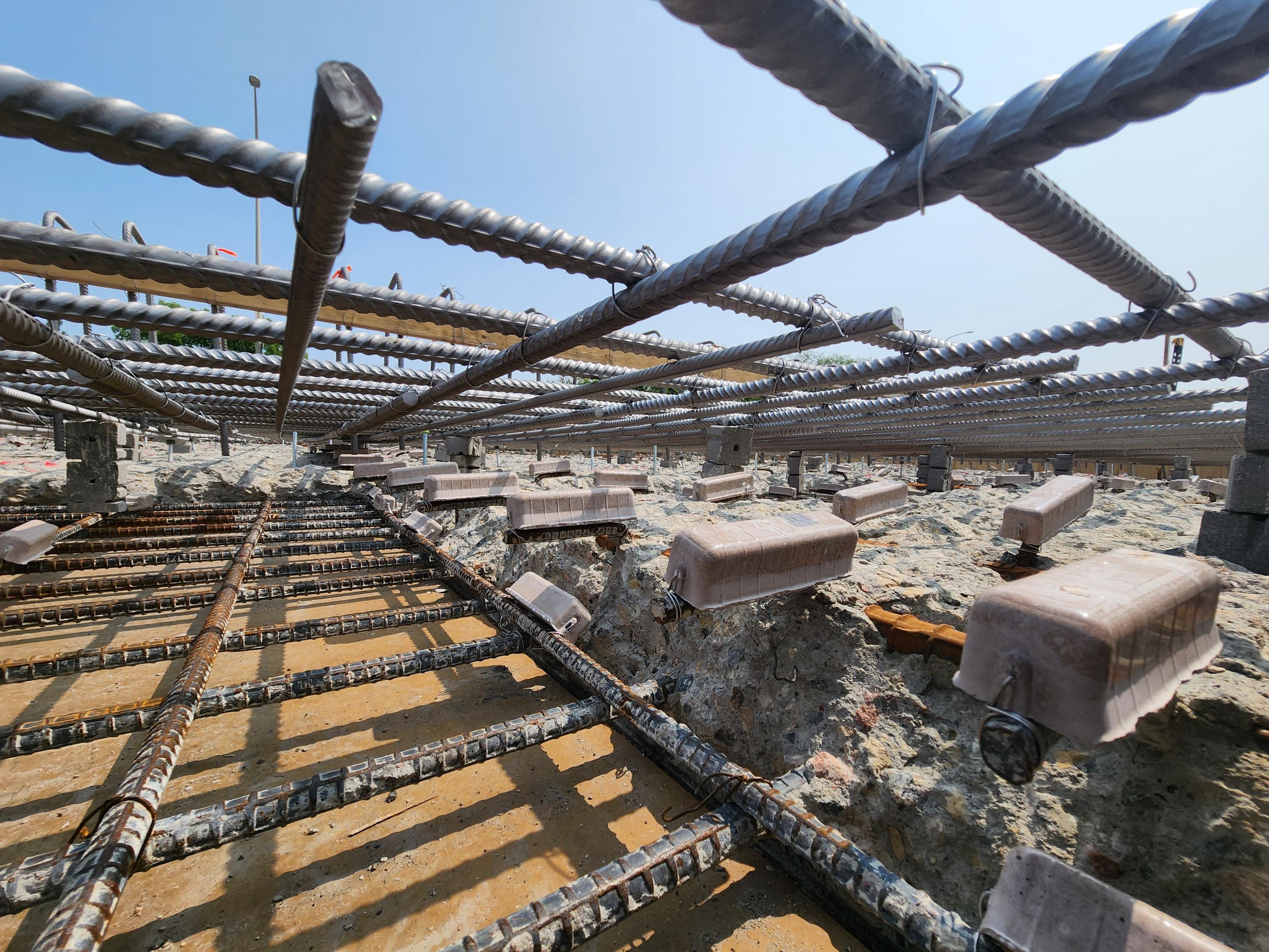 Cathodic protection components installed around reinforcing steel