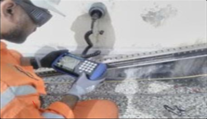 Technician reading ER probe through ring wall